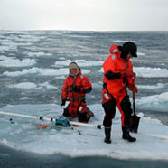 Researchers on an ice float in the Arctic sea