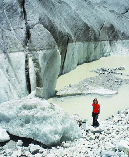 Ulyana Horodoyskyj stands next to a supraglacial lake